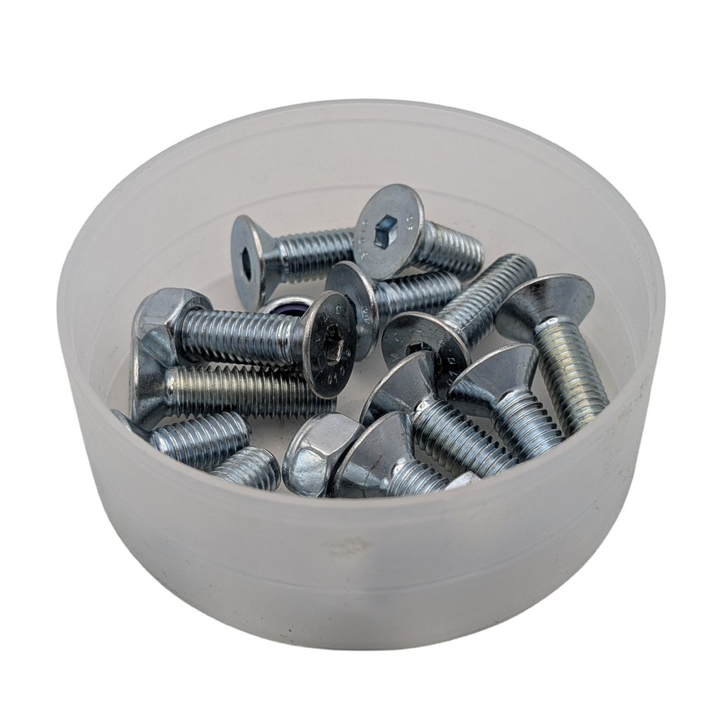 Bowl filled with metal screws on a white background